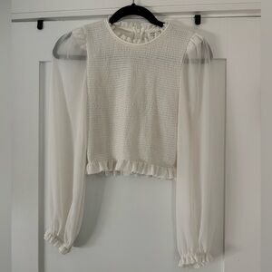 Cream smocked top with sheer sleeves